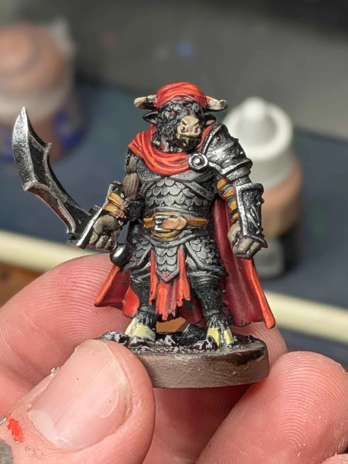 Hand-painted bull warrior miniature with silver armor and a red cape